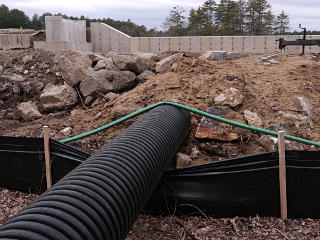 Outflow pipe below spillway