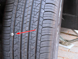 Screw embedded in tire tread