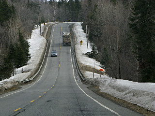 log truck pulling an uphill