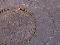 Pavement cracking around new manhole